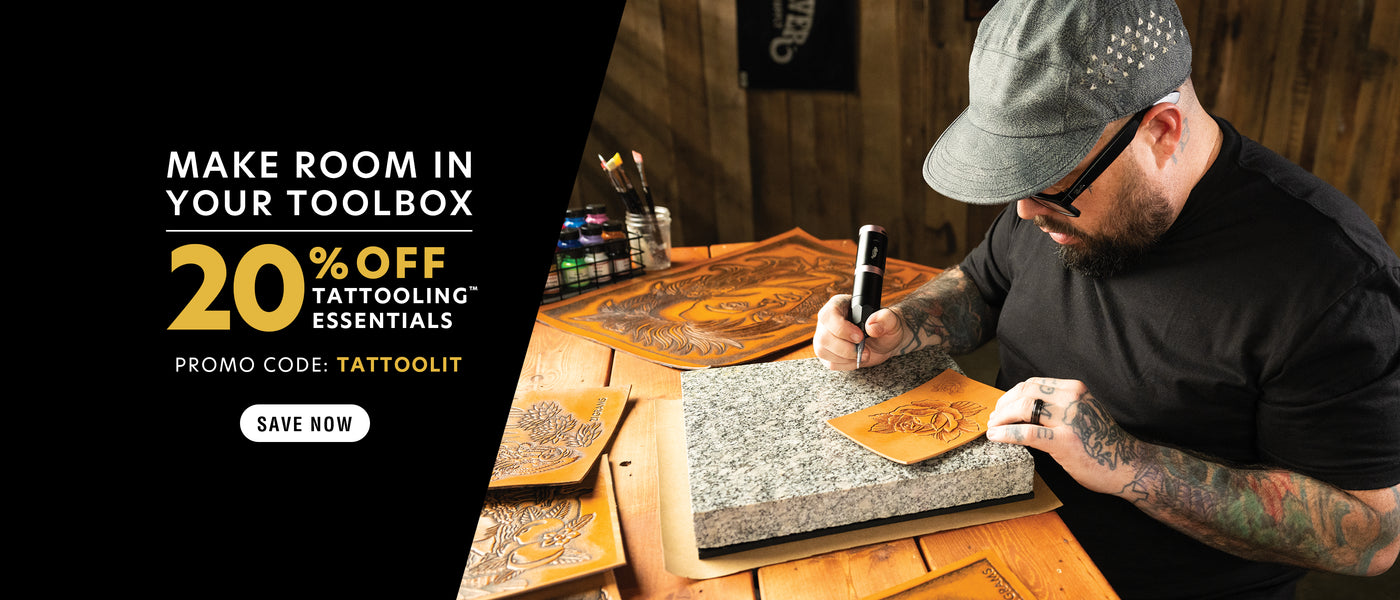 Man engraving detailed designs into leather using a handheld tool at a wooden workspace, surrounded by carved leather pieces; promotional banner offering 20% off tattooling essentials with code “TATTOOLIT.”